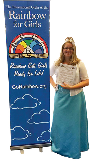 image of rainbow girl with gown near banner